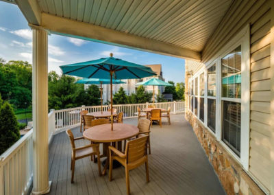Saucon View clubhouse deck overlooking swimming pool and lush greenery in Bethlehem
