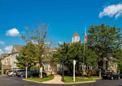 Far shot of Saucon View apartment leasing office and clubhouse in Bethlehem, PA with U.S. flag flying